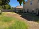 Large backyard with patchy grass and a view of the house at 2474 E Westchester Dr, Chandler, AZ 85249
