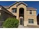 Two-story house with a tan exterior, two-car garage, and well-manicured landscaping at 2474 E Westchester Dr, Chandler, AZ 85249