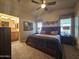 Spacious Primary bedroom with large bed, ensuite bathroom access, and ceiling fan at 650 N Hawes Rd # 2729, Mesa, AZ 85207