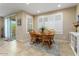 Bright dining area with wood table and chairs,tile flooring, and access to a patio at 26304 W Tina Ln, Buckeye, AZ 85396