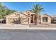 Tan two-story house with a two-car garage and desert landscaping at 12430 W Virginia Ave, Avondale, AZ 85392