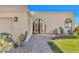 Front entrance of a home with a walkway and wrought iron gate at 3800 E Lincoln Dr # 42, Phoenix, AZ 85018
