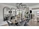 Modern dining area with a long table and statement lighting at 3800 E Lincoln Dr # 42, Phoenix, AZ 85018