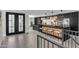 Modern kitchen with black and wood cabinets and a large island at 3800 E Lincoln Dr # 42, Phoenix, AZ 85018