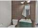 Modern bathroom with green vanity and unique mirror at 3800 E Lincoln Dr # 42, Phoenix, AZ 85018