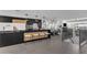 Modern kitchen with black cabinetry, a large island, and stainless steel appliances at 3800 E Lincoln Dr # 42, Phoenix, AZ 85018