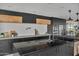 Modern kitchen with black cabinetry, wood accents, and expansive island at 3800 E Lincoln Dr # 42, Phoenix, AZ 85018