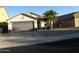 Single-story house exterior with a two-car garage and small front yard at 3955 N 294Th Ln, Buckeye, AZ 85396