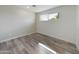 Simple bedroom with vinyl plank flooring and a large window at 1840 E Sunland Ave, Phoenix, AZ 85040