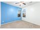 Well-lit bedroom featuring two windows, blue accent wall, and carpet flooring at 13029 W Campbell Ave, Litchfield Park, AZ 85340