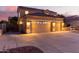 Two-story house with a tan facade, three-car garage, and landscaped yard at 13029 W Campbell Ave, Litchfield Park, AZ 85340