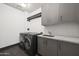 Modern laundry room with washer, dryer, and ample storage at 15215 N Kierland Blvd # 531, Scottsdale, AZ 85254