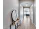 Light and airy entryway with a console table and large round mirror at 2925 W Lynx Dr, San Tan Valley, AZ 85144