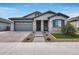 Modern two-story house with a gray facade, stone accents, and a landscaped lawn at 2925 W Lynx Dr, San Tan Valley, AZ 85144