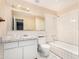 Bathroom with shower, toilet, vanity, and white tiled walls at 7340 W Glenrosa Ave, Phoenix, AZ 85033