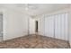 Bedroom with tiled floors and bifold closet doors at 7340 W Glenrosa Ave, Phoenix, AZ 85033