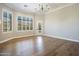 Spacious bedroom with hardwood floors, plantation shutters, and a chandelier at 10007 E Ridgerunner Dr, Scottsdale, AZ 85255