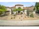 Stunning curb appeal of a two-story home with a beautifully landscaped front yard at 10007 E Ridgerunner Dr, Scottsdale, AZ 85255