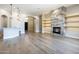 Bright and airy living room with a stone fireplace, built-ins and hardwood floors at 10007 E Ridgerunner Dr, Scottsdale, AZ 85255