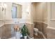 Elegant powder room with a pedestal sink and stone tile at 10007 E Ridgerunner Dr, Scottsdale, AZ 85255