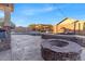 Stone fire pit and patio area with pool in background at 3514 E Parkview Dr, Gilbert, AZ 85295