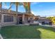 Landscaped backyard with a pool, patio, and artificial turf at 3514 E Parkview Dr, Gilbert, AZ 85295
