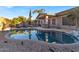 Relaxing kidney-shaped pool surrounded by a stone patio at 3514 E Parkview Dr, Gilbert, AZ 85295