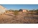 View of a shop and a house from across a large desert backyard at 9068 N Cox Rd, Casa Grande, AZ 85194