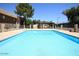 Community pool with a patio and surrounding trees at 3810 N Maryvale Pkwy # 2098, Phoenix, AZ 85031