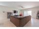 Spacious living room featuring a large sectional sofa and built-in shelving at 36409 W Pampoloma Ave, Maricopa, AZ 85138