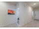 Light and airy hallway with a view of a bedroom and the front door at 36409 W Pampoloma Ave, Maricopa, AZ 85138