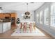 Dining room featuring hardwood floors, a modern light fixture and seating for six at 13325 W Luke Ave, Litchfield Park, AZ 85340