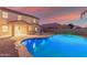 Relaxing freeform pool with patio furniture and outdoor bar at 2660 S 172Nd Dr, Goodyear, AZ 85338