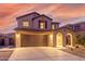 Two-story house with a two-car garage, arched entryway and desert landscaping at 2660 S 172Nd Dr, Goodyear, AZ 85338