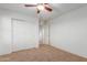 Bright bedroom with double doors closet and ceiling fan at 2660 S 172Nd Dr, Goodyear, AZ 85338