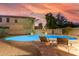 Luminous blue pool with lounge chairs and a stone accent wall at 2660 S 172Nd Dr, Goodyear, AZ 85338