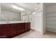 Double-sink vanity, walk-in shower, and built-in shelving at 2660 S 172Nd Dr, Goodyear, AZ 85338