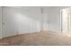 Cozy bedroom with neutral carpet, double door closet, and access to a bathroom at 2660 S 172Nd Dr, Goodyear, AZ 85338