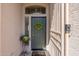 Elegant front door with a wreath and a decorative metal gate at 17141 N Oliveto Ave, Maricopa, AZ 85138