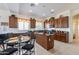 Spacious kitchen with an island, wood cabinets, and granite countertops at 17141 N Oliveto Ave, Maricopa, AZ 85138