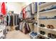 Large walk-in closet with shelving and hanging rods at 17141 N Oliveto Ave, Maricopa, AZ 85138