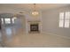 Living room with tile floors, fireplace, and chandelier at 18071 W Douglas Way, Surprise, AZ 85374