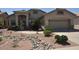 Single story home with two-car garage and rock landscaping at 18071 W Douglas Way, Surprise, AZ 85374