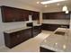 Spacious kitchen with dark wood cabinets and granite counters at 18071 W Douglas Way, Surprise, AZ 85374