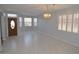 Bright dining room with tile floors and chandelier at 18071 W Douglas Way, Surprise, AZ 85374