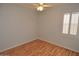 Bright bedroom with light walls, wood-look flooring, and window shutters at 18071 W Douglas Way, Surprise, AZ 85374