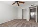 Spacious bedroom with carpeted floor, ceiling fan, and access to balcony at 6705 W Orchid Ln, Peoria, AZ 85345