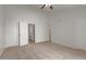 Large bedroom with carpeted floor, double closets and access to hallway and stairs at 6705 W Orchid Ln, Peoria, AZ 85345