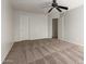 Well-lit bedroom with carpeted floor and double closets at 6705 W Orchid Ln, Peoria, AZ 85345