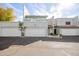 Two-story stucco townhouse with attached garage and front patio at 6705 W Orchid Ln, Peoria, AZ 85345